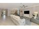 Spacious living room with tile flooring, neutral colors, and a seamless transition to the dining area at 15033 Spanish Point Dr, Port Charlotte, FL 33981