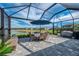 Spacious screened lanai featuring a dining area and built in grill, perfect for entertaining guests at 15033 Spanish Point Dr, Port Charlotte, FL 33981