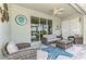 Inviting patio with outdoor seating, a ceiling fan, and a view of the serene surroundings, perfect for leisure at 15033 Spanish Point Dr, Port Charlotte, FL 33981