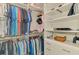 Organized walk-in closet with custom shelving, hanging rods, and ample storage for clothes and accessories at 15033 Spanish Point Dr, Port Charlotte, FL 33981