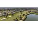 Breathtaking aerial view of a home located near a lake and golf course at 1921 Pebble Beach Ct, Venice, FL 34293