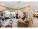 Spacious living room with comfortable seating, a ceiling fan, and sliding glass doors to a backyard at 1921 Pebble Beach Ct, Venice, FL 34293