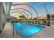 Screened in pool with crystal clear water and a great sunset view at 1921 Pebble Beach Ct, Venice, FL 34293