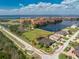 Stunning aerial view of a home near a lake, complemented by picturesque landscaping at 197 Colony Point Dr, Punta Gorda, FL 33950