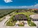 Expansive aerial view showcasing a beautiful home with lush landscaping and palm trees at 197 Colony Point Dr, Punta Gorda, FL 33950