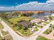 Detailed aerial view of the home surrounded by tropical landscaping and a paved driveway at 197 Colony Point Dr, Punta Gorda, FL 33950