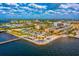 Breathtaking aerial view of a waterfront complex with palm trees, a pier, and a colorful seating area at 197 Colony Point Dr, Punta Gorda, FL 33950