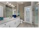 Light and airy bathroom with white cabinets, a marble countertop, and walk-in shower at 197 Colony Point Dr, Punta Gorda, FL 33950