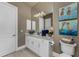 Neutral bathroom with a white vanity, large mirror, and modern lighting fixtures at 197 Colony Point Dr, Punta Gorda, FL 33950