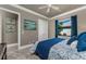 Bedroom with a large window, blue curtains, and a patterned blue comforter on the bed at 197 Colony Point Dr, Punta Gorda, FL 33950