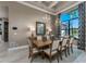 Bright dining area with stylish lighting, a wooden table set for eight, and a large window offering a bright, welcoming space at 197 Colony Point Dr, Punta Gorda, FL 33950