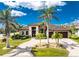 Stunning single-story home with a manicured lawn, stone driveway, and multiple palm trees enhancing its curb appeal at 197 Colony Point Dr, Punta Gorda, FL 33950