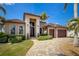 Attractive single-story home featuring a well-kept lawn, mature landscaping, and a spacious driveway leading to the garage at 197 Colony Point Dr, Punta Gorda, FL 33950