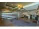 Bright garage area with two garage doors, tiled floors, overhead lighting, and workout equipment to the right at 197 Colony Point Dr, Punta Gorda, FL 33950