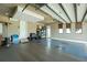 Spacious garage featuring tiled floors, three windows with bamboo blinds, storage shelves, and a white door at 197 Colony Point Dr, Punta Gorda, FL 33950