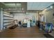 Spacious garage featuring wood floors and ample storage for vehicles and recreational equipment at 197 Colony Point Dr, Punta Gorda, FL 33950