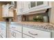 Bright kitchen featuring white cabinets, granite counters, a tile backsplash, and modern appliances at 197 Colony Point Dr, Punta Gorda, FL 33950