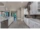 Spacious kitchen with a large island, stainless steel appliances, and access to the outdoor dining area and pool at 197 Colony Point Dr, Punta Gorda, FL 33950