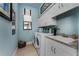 Well-organized laundry room with ample cabinetry, a utility sink, and a front-loading washer and dryer at 197 Colony Point Dr, Punta Gorda, FL 33950