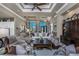 Expansive living room with tray ceiling, sophisticated decor, and views of the entrance and adjacent dining area at 197 Colony Point Dr, Punta Gorda, FL 33950