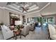 Inviting living area with a coffered ceiling, wood accents, and sliding glass doors to the outdoor living and dining areas at 197 Colony Point Dr, Punta Gorda, FL 33950
