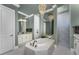 An elegant main bathroom with a soaking tub beneath a decorative chandelier and a large walk-in shower at 197 Colony Point Dr, Punta Gorda, FL 33950