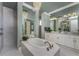 This main bathroom features a soaking tub, walk-in shower, and dual vanities with bright white cabinetry at 197 Colony Point Dr, Punta Gorda, FL 33950
