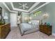 This primary bedroom offers a tray ceiling, chandelier, and serene color palette at 197 Colony Point Dr, Punta Gorda, FL 33950