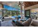 Comfortable seating and summer kitchen in the lanai overlooking the pool and palm trees at 197 Colony Point Dr, Punta Gorda, FL 33950