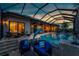 Elegant screened pool area with comfortable seating, a dolphin statue, and ambient lighting for relaxing evenings at 197 Colony Point Dr, Punta Gorda, FL 33950