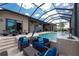 Elegant screened pool area with comfortable seating, a dolphin statue, and bright natural light at 197 Colony Point Dr, Punta Gorda, FL 33950