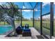 Elegant screened pool area with a dolphin statue, outdoor dining, and serene landscaping under a bright sky at 197 Colony Point Dr, Punta Gorda, FL 33950
