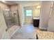 Bathroom featuring a walk-in shower with glass door and a double vanity at 2201 Como St, Port Charlotte, FL 33948
