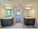 Dual vanities in Primary bathroom with granite countertop and tile flooring at 2201 Como St, Port Charlotte, FL 33948