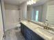 Bright bathroom with a double sink vanity and a tub and shower combo at 2201 Como St, Port Charlotte, FL 33948