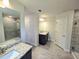 Spacious bathroom featuring a double vanity, walk-in shower, and tile flooring at 2201 Como St, Port Charlotte, FL 33948