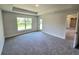 A bright bedroom with carpet, a large window, and neutral paint at 2201 Como St, Port Charlotte, FL 33948