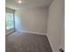 Bedroom with carpet and a window overlooking trees at 2201 Como St, Port Charlotte, FL 33948
