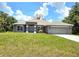 Beautiful single-story home featuring a well-manicured lawn and a two-car garage at 2201 Como St, Port Charlotte, FL 33948