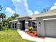 Inviting front entrance with well manicured landscape and a freshly painted exterior at 2201 Como St, Port Charlotte, FL 33948
