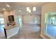 Spacious living area with tile floors offers views to the kitchen and backyard at 2201 Como St, Port Charlotte, FL 33948