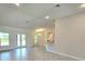 Open concept living room with tile floors seamlessly flows into the kitchen and dining area at 2201 Como St, Port Charlotte, FL 33948