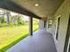 A covered patio overlooking the backyard and green space at 2201 Como St, Port Charlotte, FL 33948