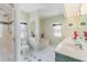 Bathroom featuring shower, separate tub, dual sinks and white tile flooring at 23488 Almond Ave, Port Charlotte, FL 33954