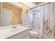Bathroom with a tub/shower, large mirror, and sink at 23488 Almond Ave, Port Charlotte, FL 33954