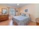 Bedroom featuring a ceiling fan, wood floors, and a light yellow paint scheme at 23488 Almond Ave, Port Charlotte, FL 33954