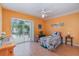 Bedroom with wood floors, ceiling fan, and sliding glass door leading to the lanai at 23488 Almond Ave, Port Charlotte, FL 33954