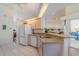 Bright kitchen with modern appliances and breakfast bar, perfect for casual dining and entertaining at 23488 Almond Ave, Port Charlotte, FL 33954