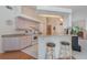 Bright kitchen features sleek appliances, white cabinets, and a breakfast bar with seating at 23488 Almond Ave, Port Charlotte, FL 33954