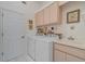 Laundry room featuring washer, dryer, storage cabinets, and a utility sink at 23488 Almond Ave, Port Charlotte, FL 33954